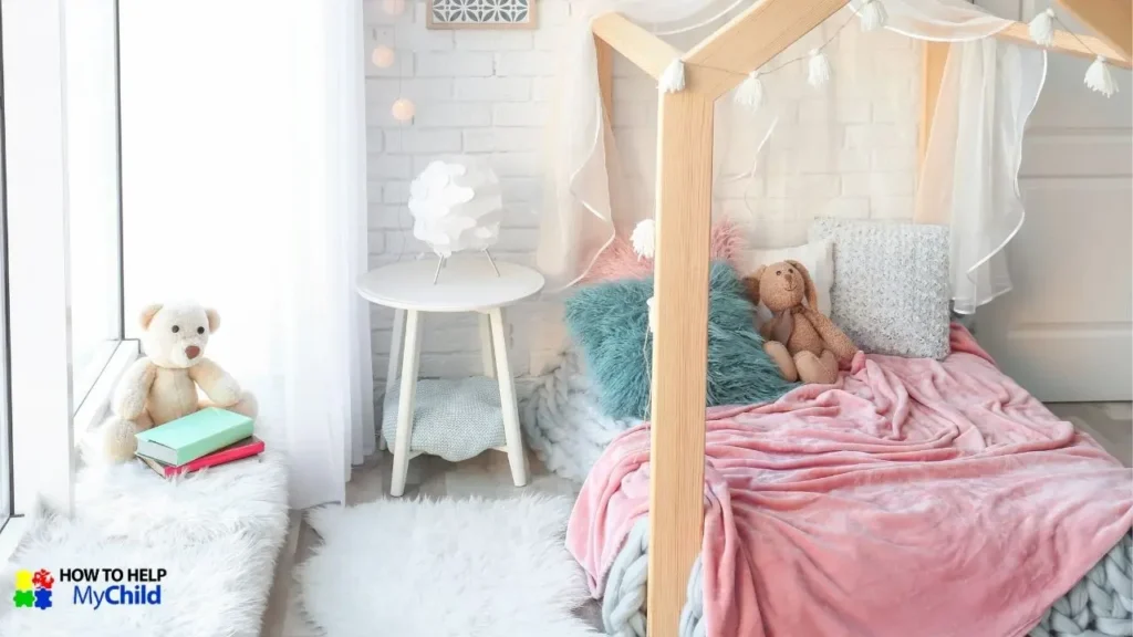 A beautifully designed cozy bedtime nook with soft pastel blankets, fluffy pillows, and a canopy bed frame, creating a peaceful and sensory-friendly sleep environment. A plush teddy bear and books sit nearby, reinforcing the importance of a calming bedtime routine for kids with autism and ADHD. The soft lighting and inviting textures make this space ideal for winding down before sleep. The "How to Help My Child" logo is visible in the corner.