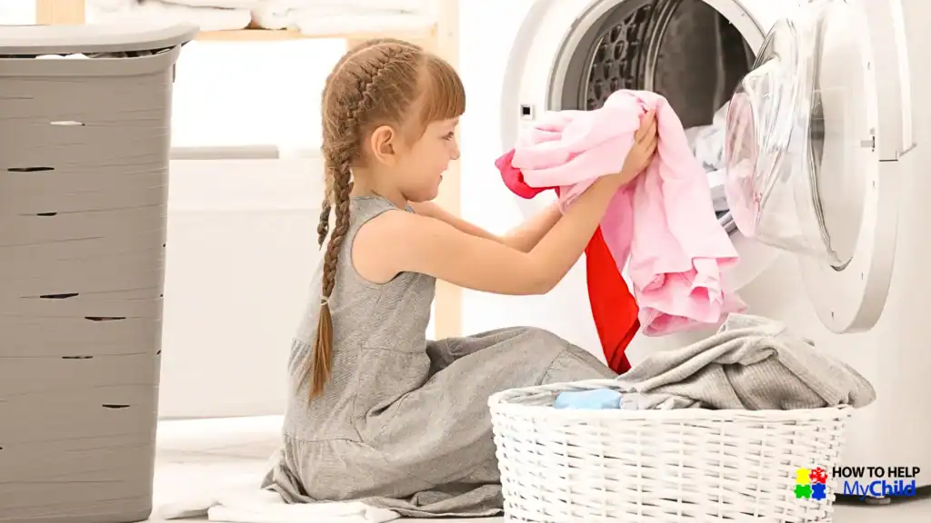 Young girl confidently loading laundry as part of a visual routine supporting chores for kids with autism and ADHD, a tip from How to Help My Child.
